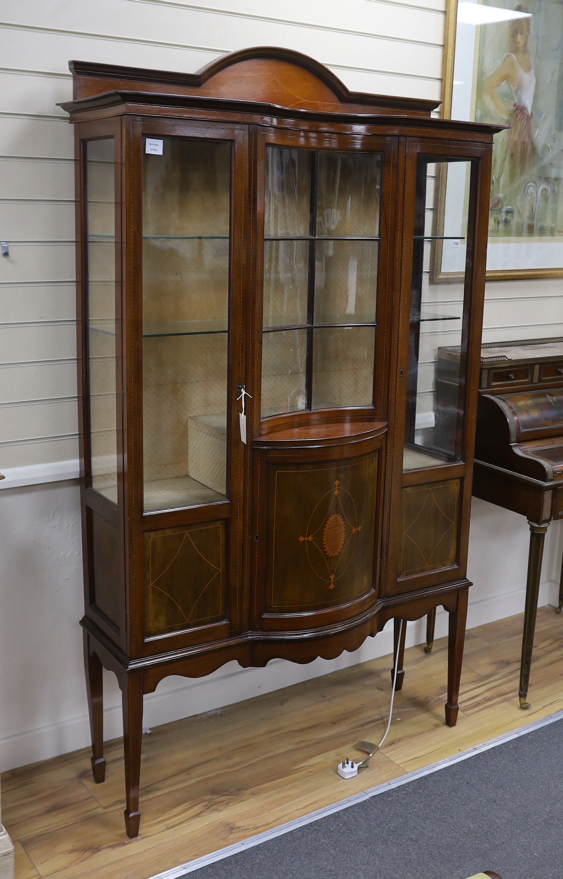 An Edwardian inlaid mahogany concave and bow front display cabinet, width 115cm, depth 36cm, height 197cm